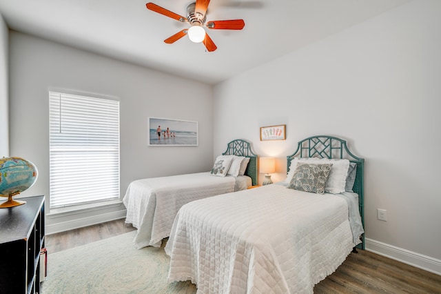 bedroom with dark hardwood / wood-style floors, multiple windows, and ceiling fan