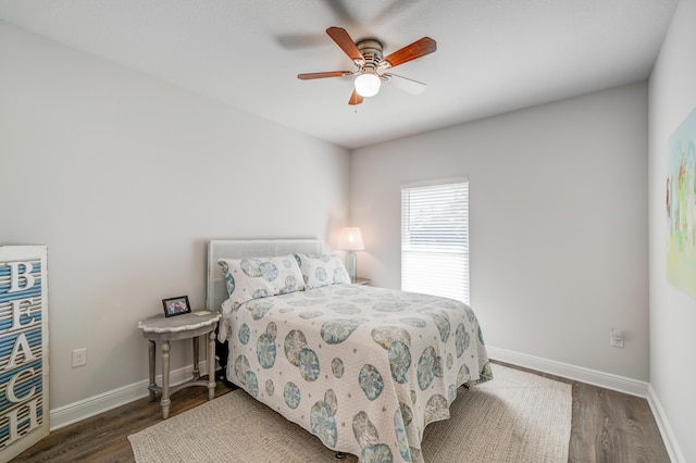 bedroom with ceiling fan and dark hardwood / wood-style floors