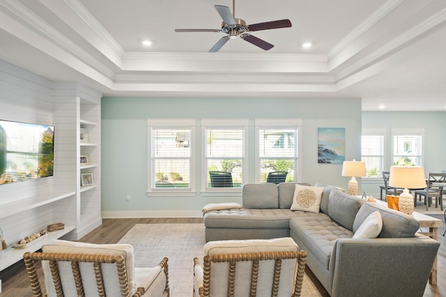 living room with ornamental molding, ceiling fan, a healthy amount of sunlight, and hardwood / wood-style floors