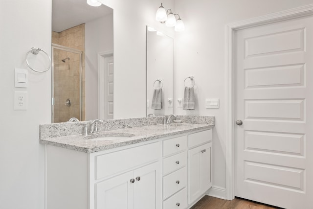 bathroom featuring vanity, hardwood / wood-style flooring, and walk in shower