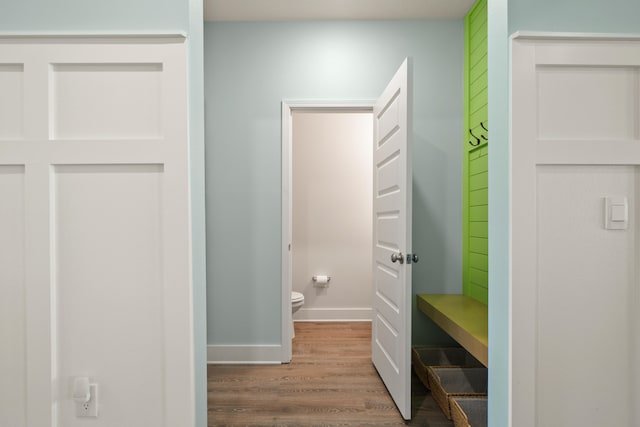 bathroom with hardwood / wood-style floors and toilet