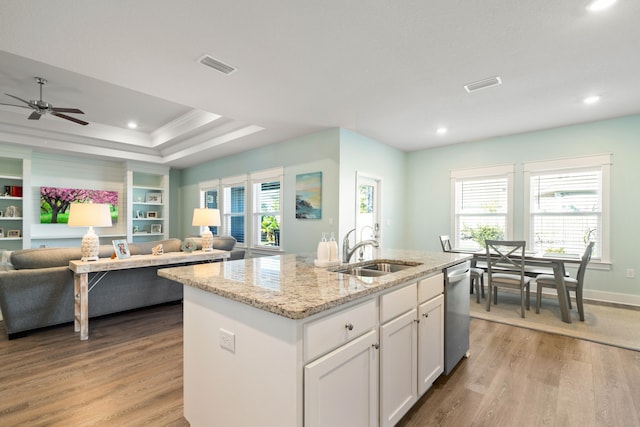 kitchen with white cabinetry, a kitchen island with sink, plenty of natural light, and sink