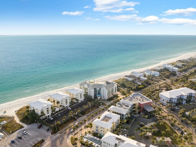 birds eye view of property featuring a beach view and a water view