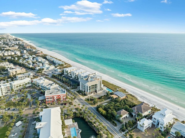 drone / aerial view featuring a water view and a beach view