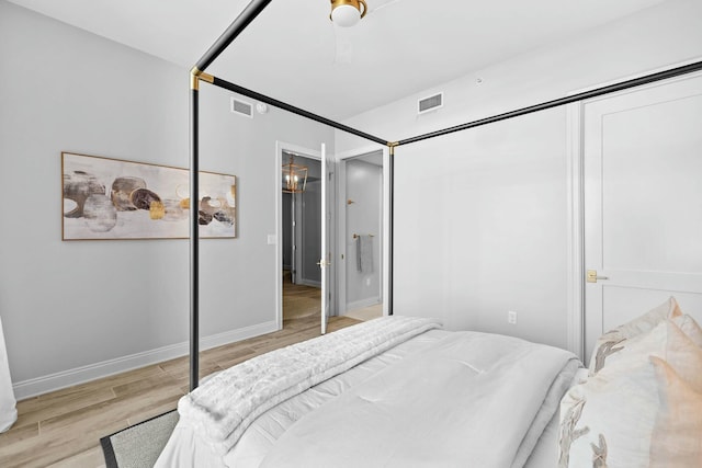 bedroom with ceiling fan, light wood-type flooring, and a closet