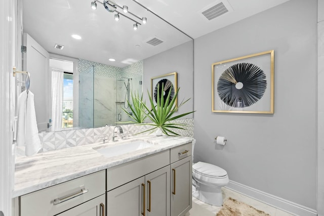 bathroom featuring tile patterned flooring, toilet, vanity, and walk in shower