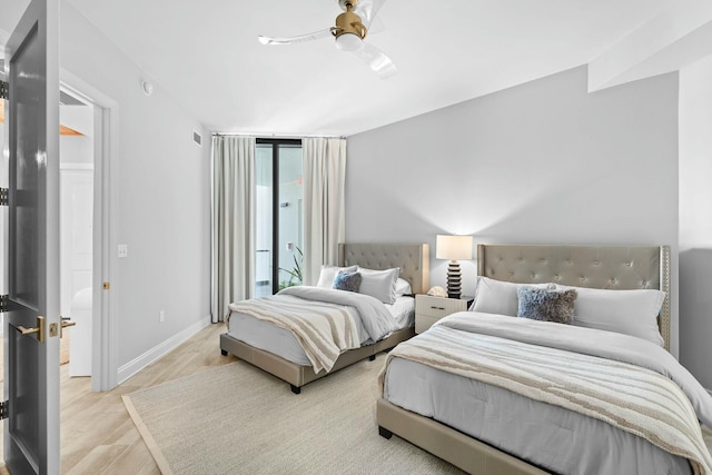 bedroom featuring ceiling fan, light hardwood / wood-style floors, and access to exterior