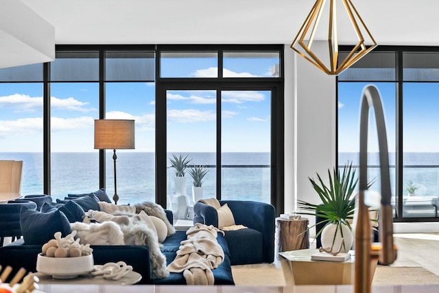 living room featuring a water view and expansive windows