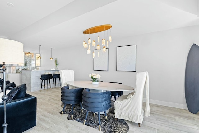 dining room featuring light hardwood / wood-style floors and a notable chandelier