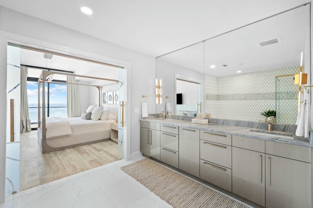 bathroom with vanity, a water view, and an enclosed shower