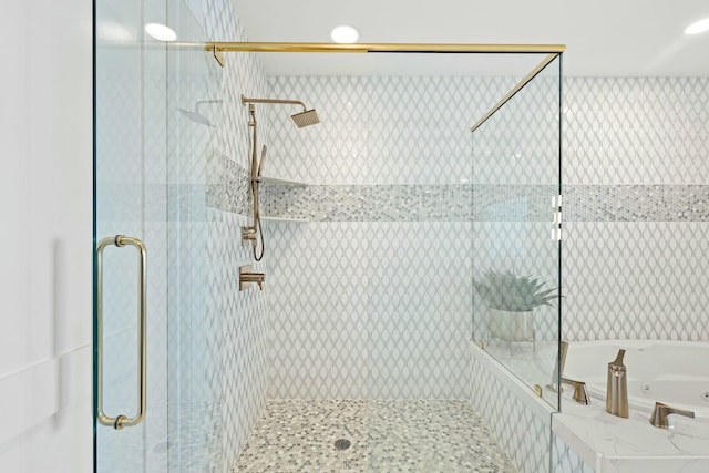 bathroom featuring separate shower and tub