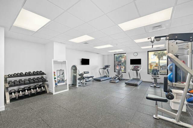 exercise room with a paneled ceiling