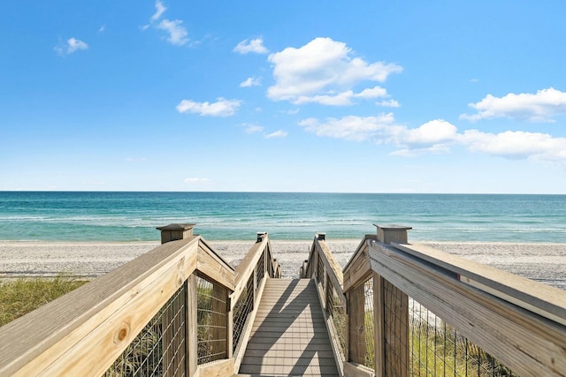 surrounding community with a water view and a view of the beach