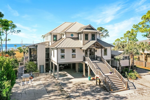 rear view of house with a water view and a carport