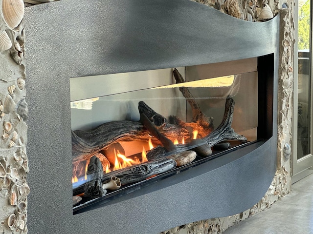 interior details featuring a fireplace and concrete floors