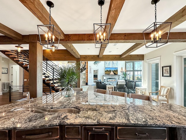 kitchen featuring stone countertops and hanging light fixtures