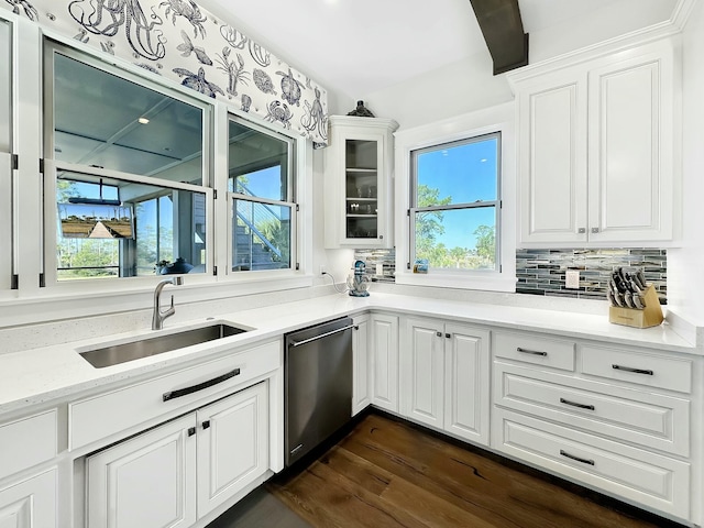 kitchen featuring dark hardwood / wood-style flooring, dishwasher, sink, and a healthy amount of sunlight