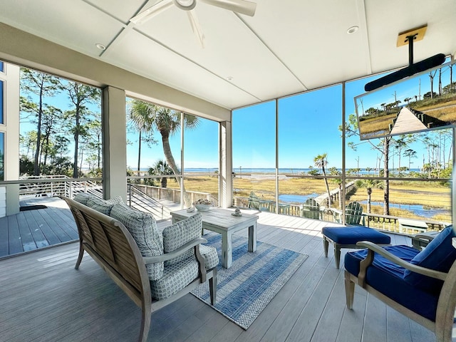 sunroom featuring a water view and a wealth of natural light