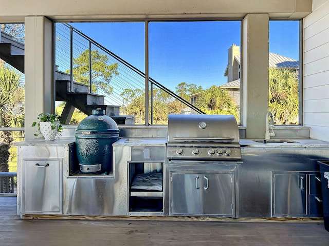 view of patio / terrace with an outdoor kitchen, area for grilling, and sink