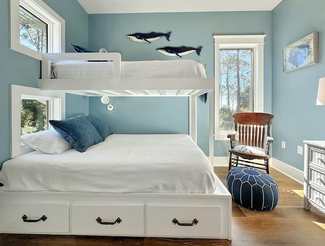 bedroom with light wood-type flooring and multiple windows