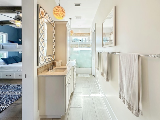 bathroom with ceiling fan, hardwood / wood-style floors, and vanity