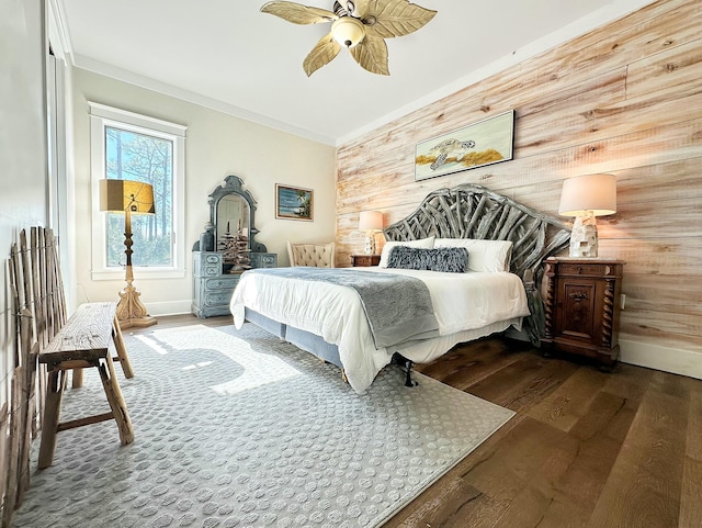 bedroom featuring hardwood / wood-style floors, ornamental molding, ceiling fan, and wooden walls