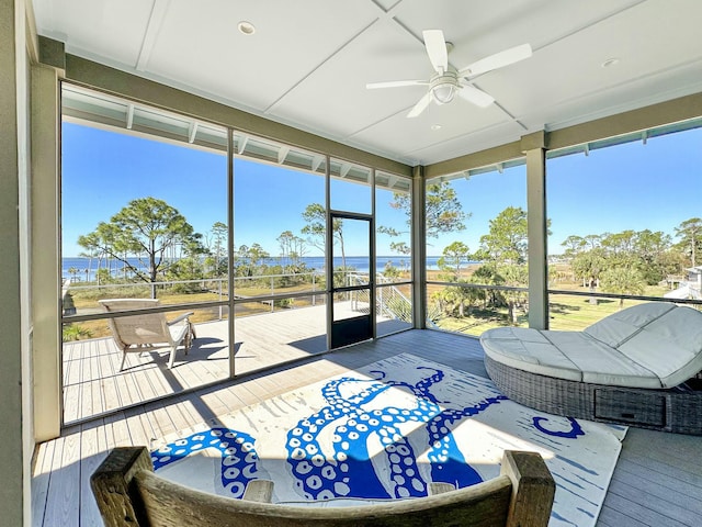 sunroom / solarium featuring ceiling fan and a healthy amount of sunlight