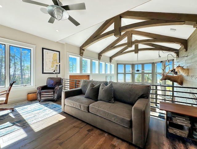 living room featuring vaulted ceiling with beams and plenty of natural light