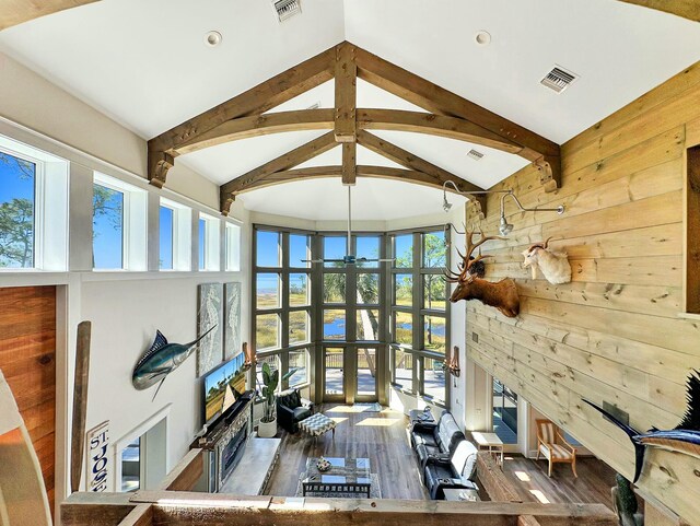 home office featuring french doors, a wealth of natural light, dark wood-type flooring, and wood walls