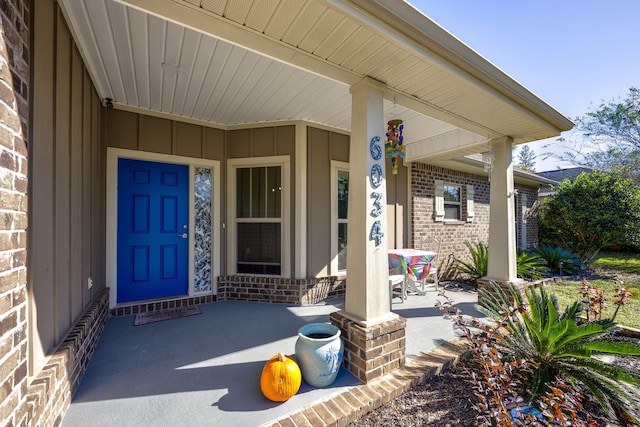 view of exterior entry with a porch