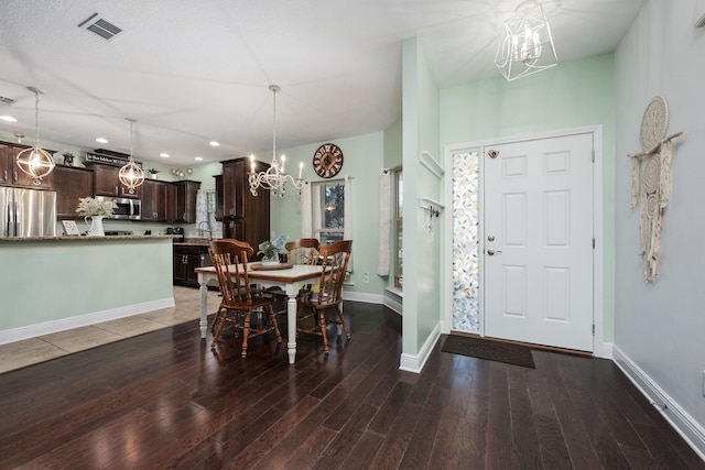 dining room featuring dark hardwood / wood-style floors and a notable chandelier