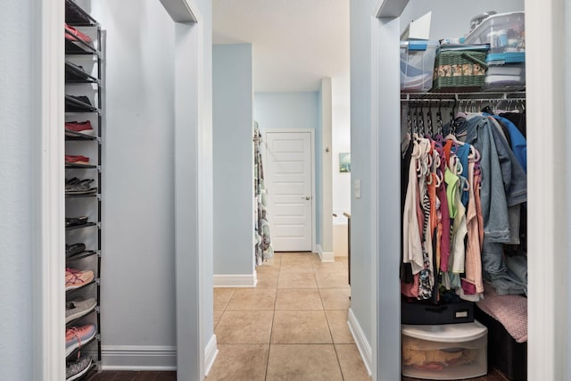 spacious closet with light tile patterned floors