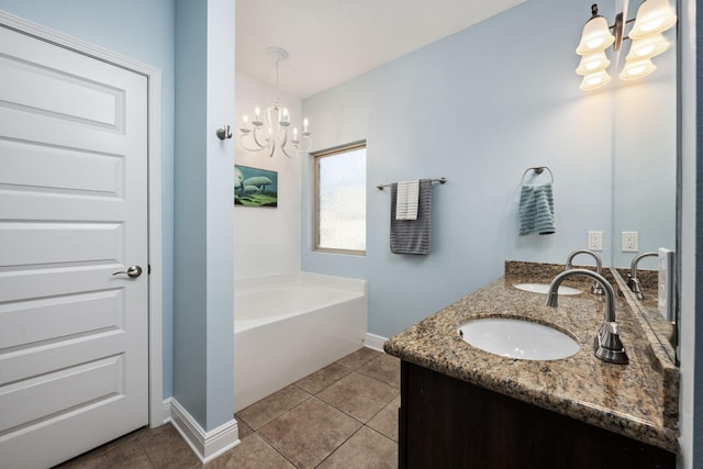 bathroom featuring a tub, tile patterned flooring, vanity, and a notable chandelier