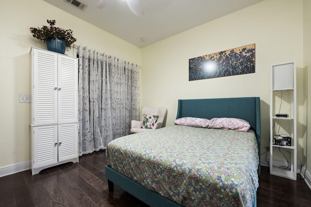 bedroom with dark hardwood / wood-style floors and ceiling fan