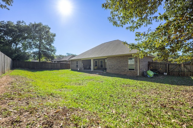 back of house featuring a lawn