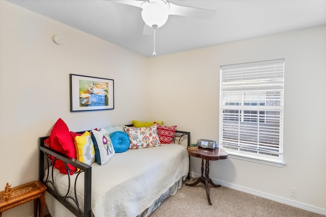 bedroom featuring light colored carpet and ceiling fan