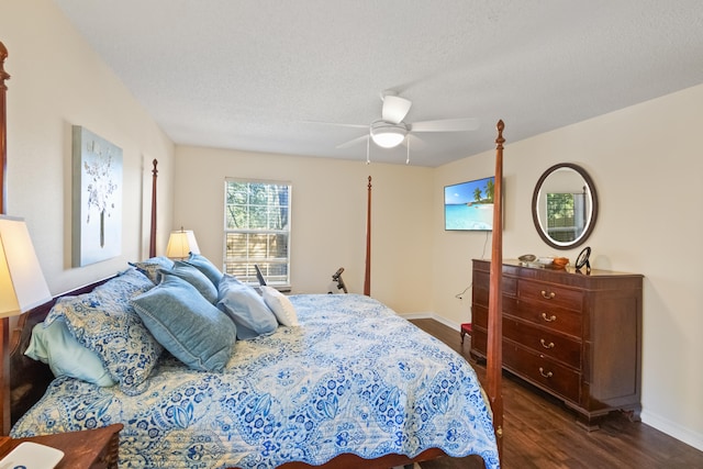 bedroom with a textured ceiling, dark hardwood / wood-style floors, and ceiling fan