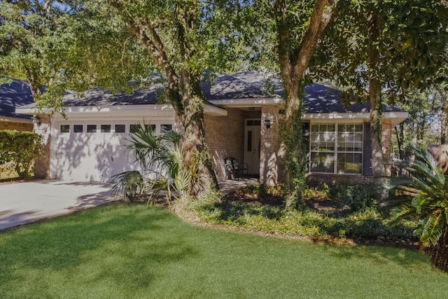 ranch-style home featuring a front lawn and a garage