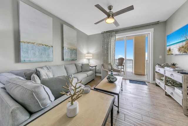 living room with ceiling fan and light hardwood / wood-style floors