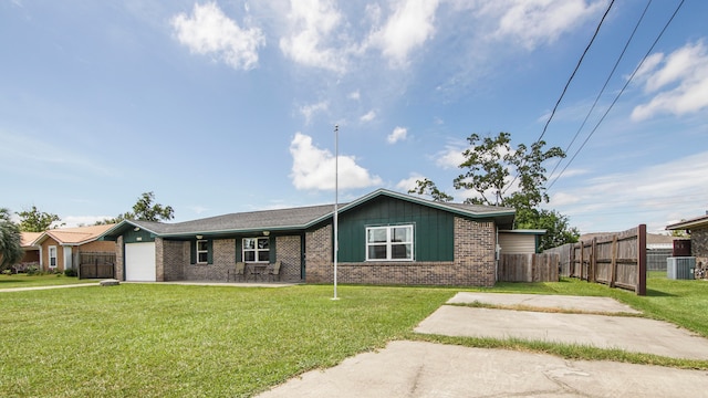 ranch-style house with cooling unit, a garage, and a front lawn