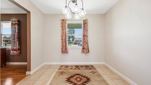 dining room featuring light wood-type flooring and an inviting chandelier