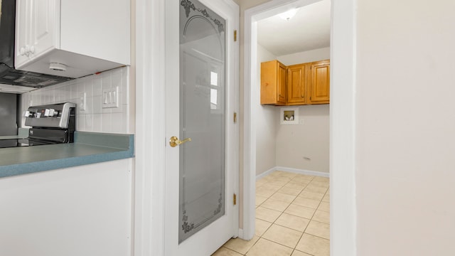 kitchen with stainless steel range and light tile patterned floors