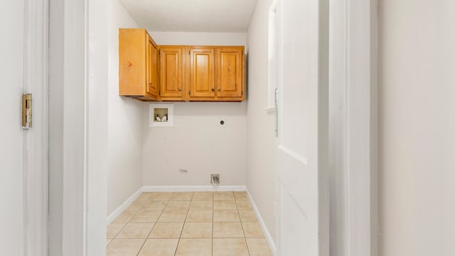 laundry room featuring hookup for an electric dryer, cabinets, light tile patterned floors, and washer hookup