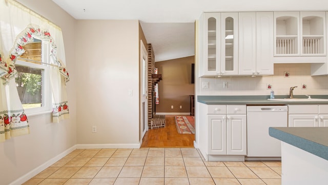 kitchen featuring white cabinets, sink, and white dishwasher