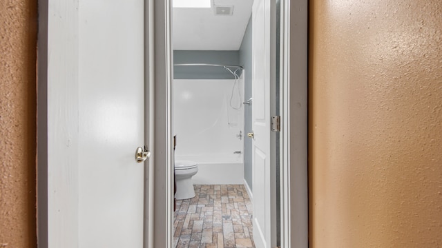 bathroom with toilet and shower / bath combination