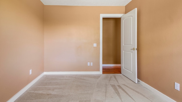 empty room with light colored carpet