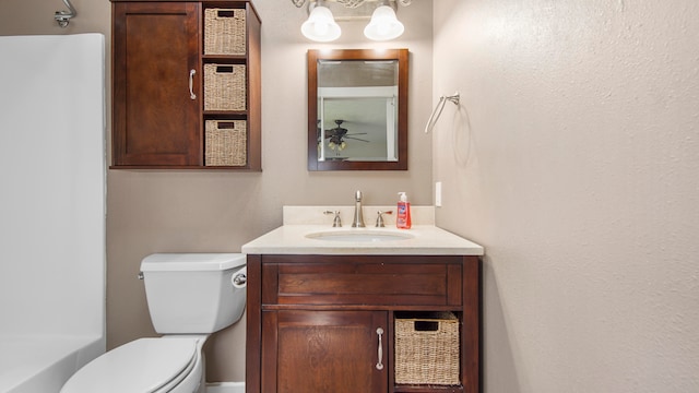 bathroom featuring a tub to relax in, vanity, and toilet