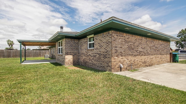 view of home's exterior with a yard, a patio, and central AC