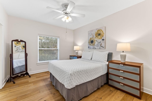 bedroom with light hardwood / wood-style flooring and ceiling fan