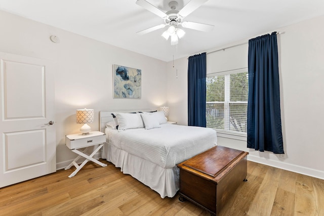 bedroom with ceiling fan and light hardwood / wood-style floors